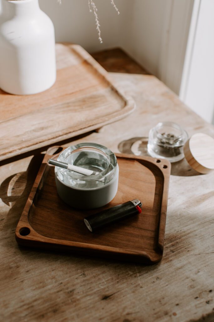 Smoking accessories- a grinder and rolling tray on top of desk