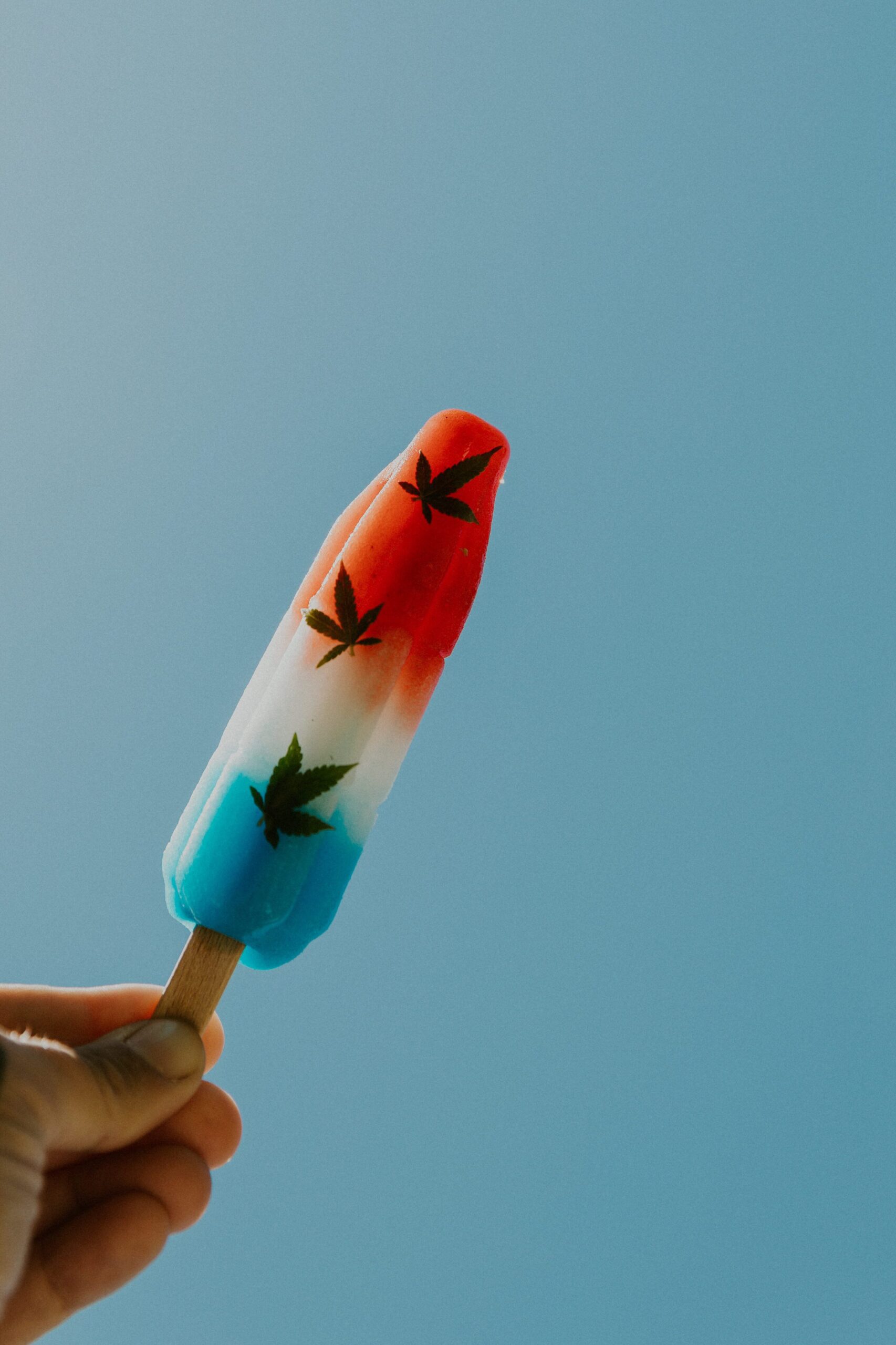 Cannabis leafs on a bomb pop with the summer sky 