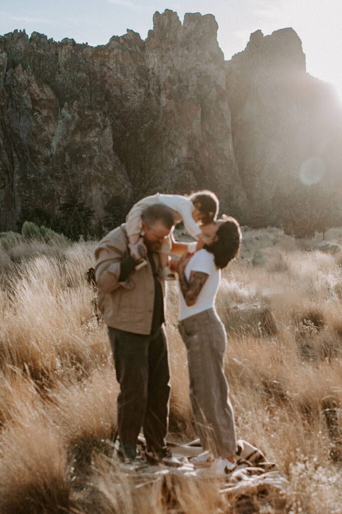 Family poses in front of rock formations at smith rock state park